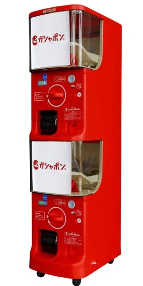 GASHAPON STATION 100の発表画像。ロボの商品画像とは別の、新型カプセル自販機です。